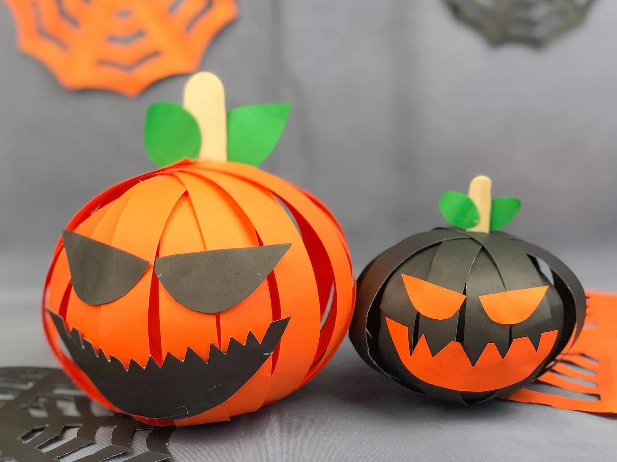 papercraft pumpkin with additional decorations with a mischievous face