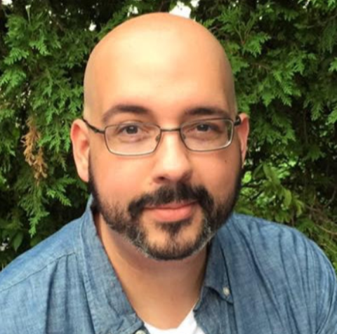 smiling man with glasses and a beard