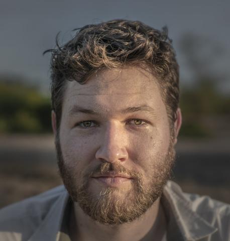 A professional headshot of a Do Space mentor with a warm, confident smile.