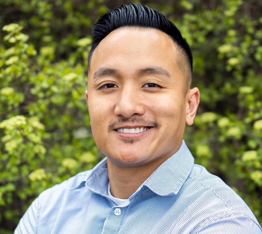 smiling man with short black hair